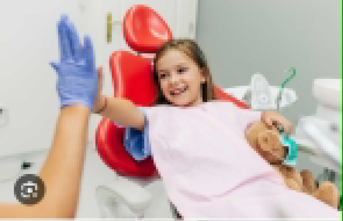 Vajzë e qeshur në karrigen e dentistit gjatë vizitës